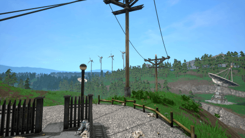 Landscape image of the terrain with wind turbines in the background.